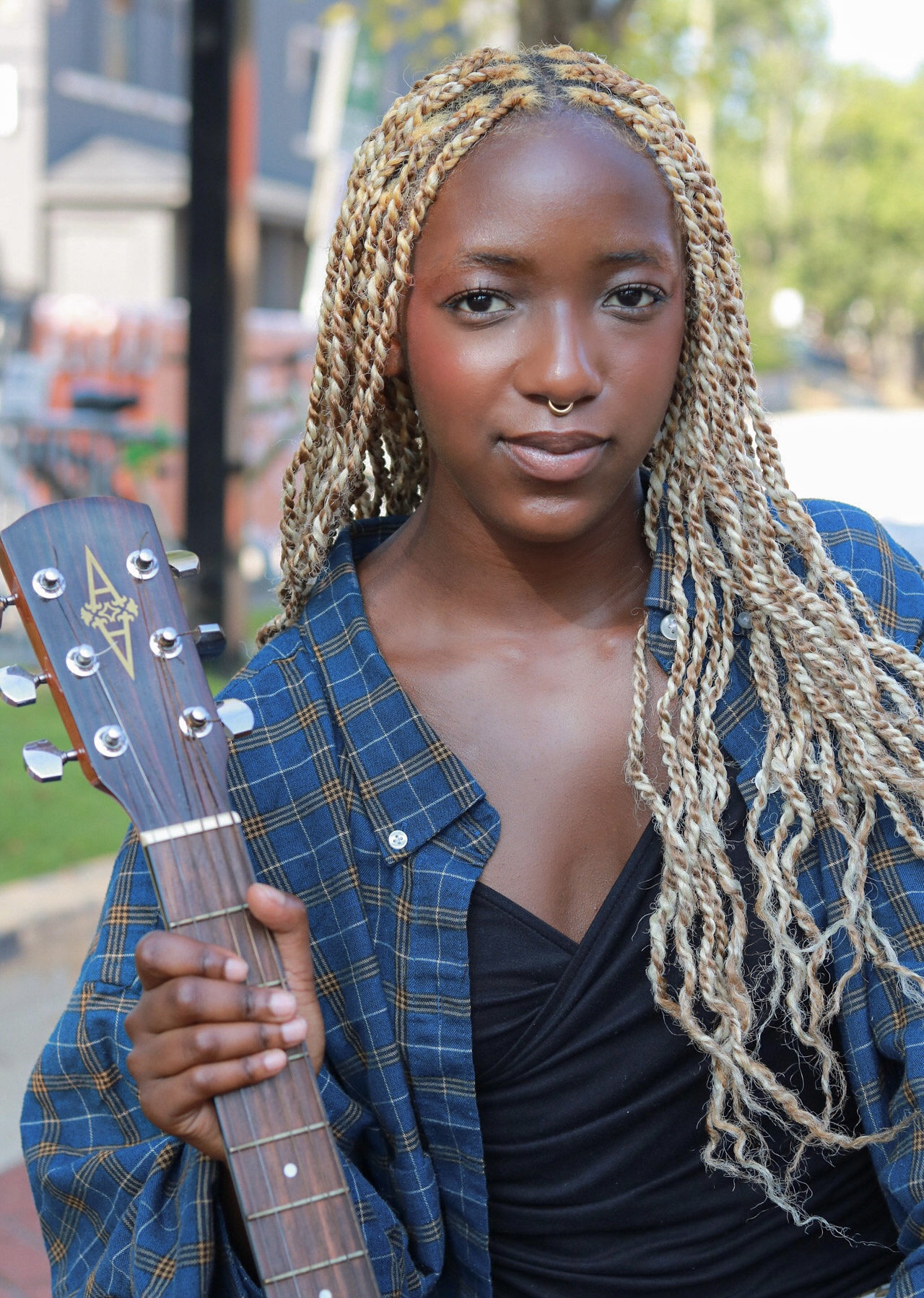 Amauriah holding a guitar outdoors