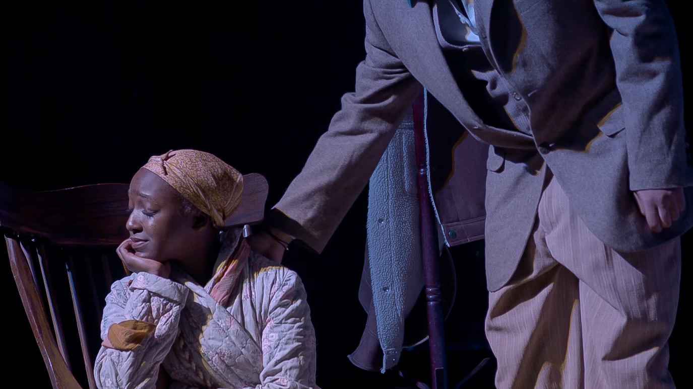 Amauriah kneeling during a theatrical scene